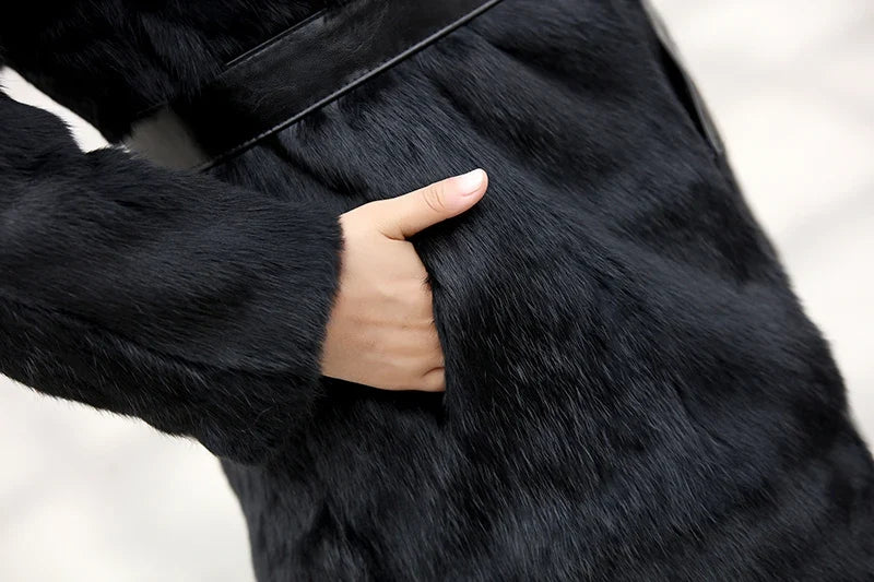 Women's black winter coat made of soft material with fur collar and tie belt
