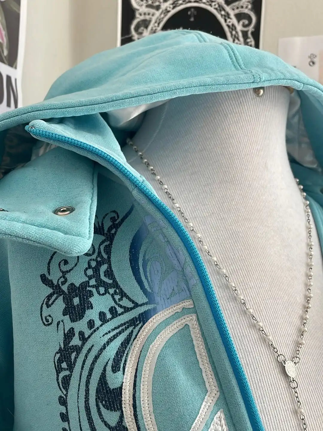 Women's turquoise hoodie with zipper and graphic print