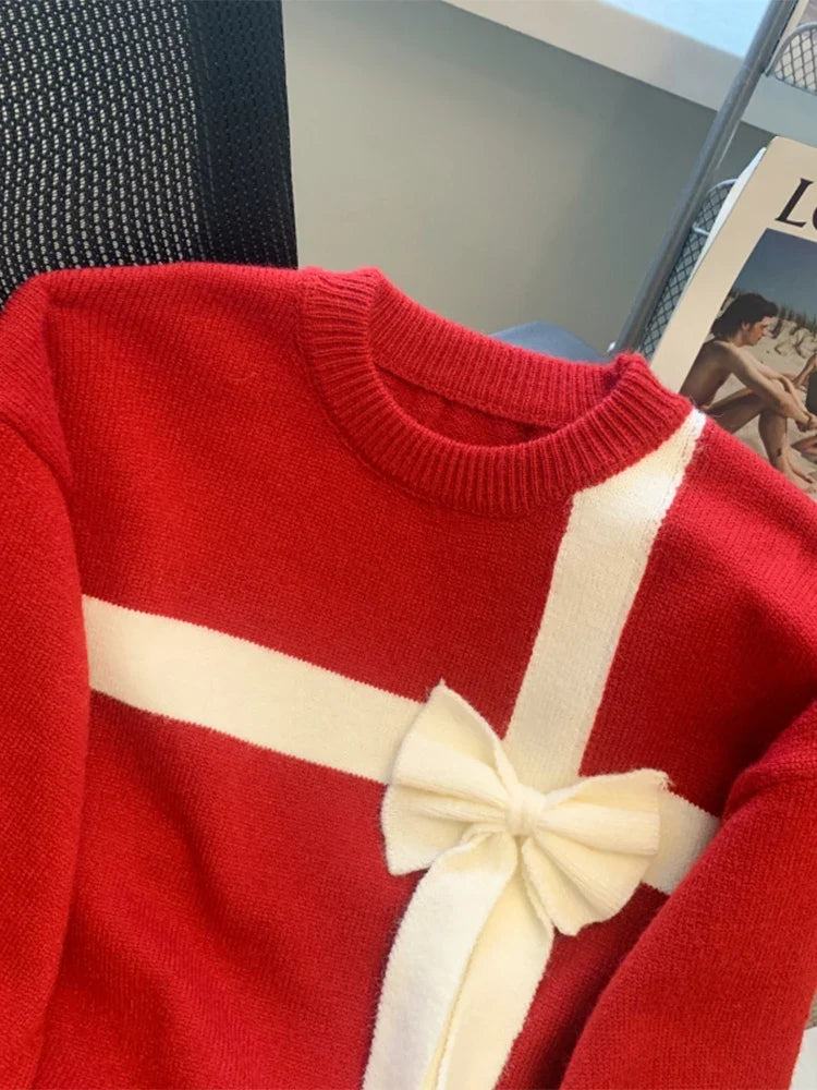 Red sweater with white bow detail and crew neckline
