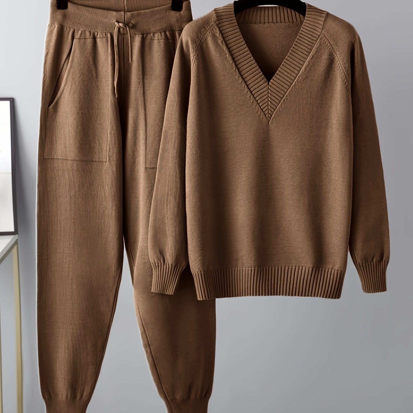 Two-piece women’s knitted set with a V-neck sweater and jogger pants in a beige ribbed-knit design