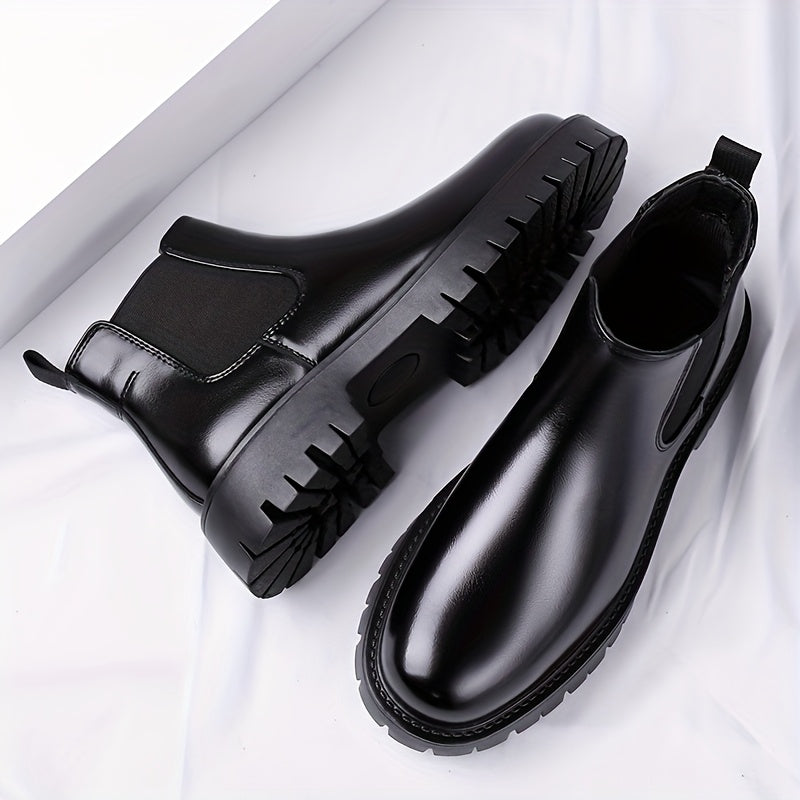 Black Chelsea boots with elastic panels and a lug sole