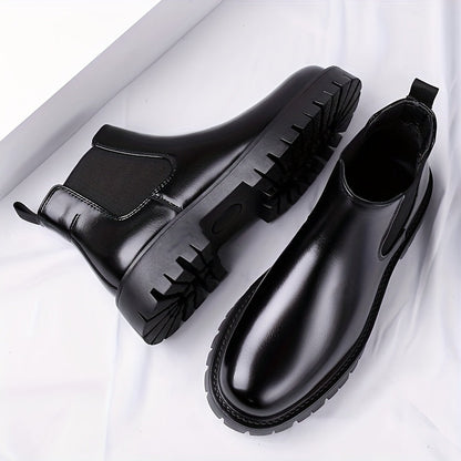 Black Chelsea boots with elastic panels and a lug sole