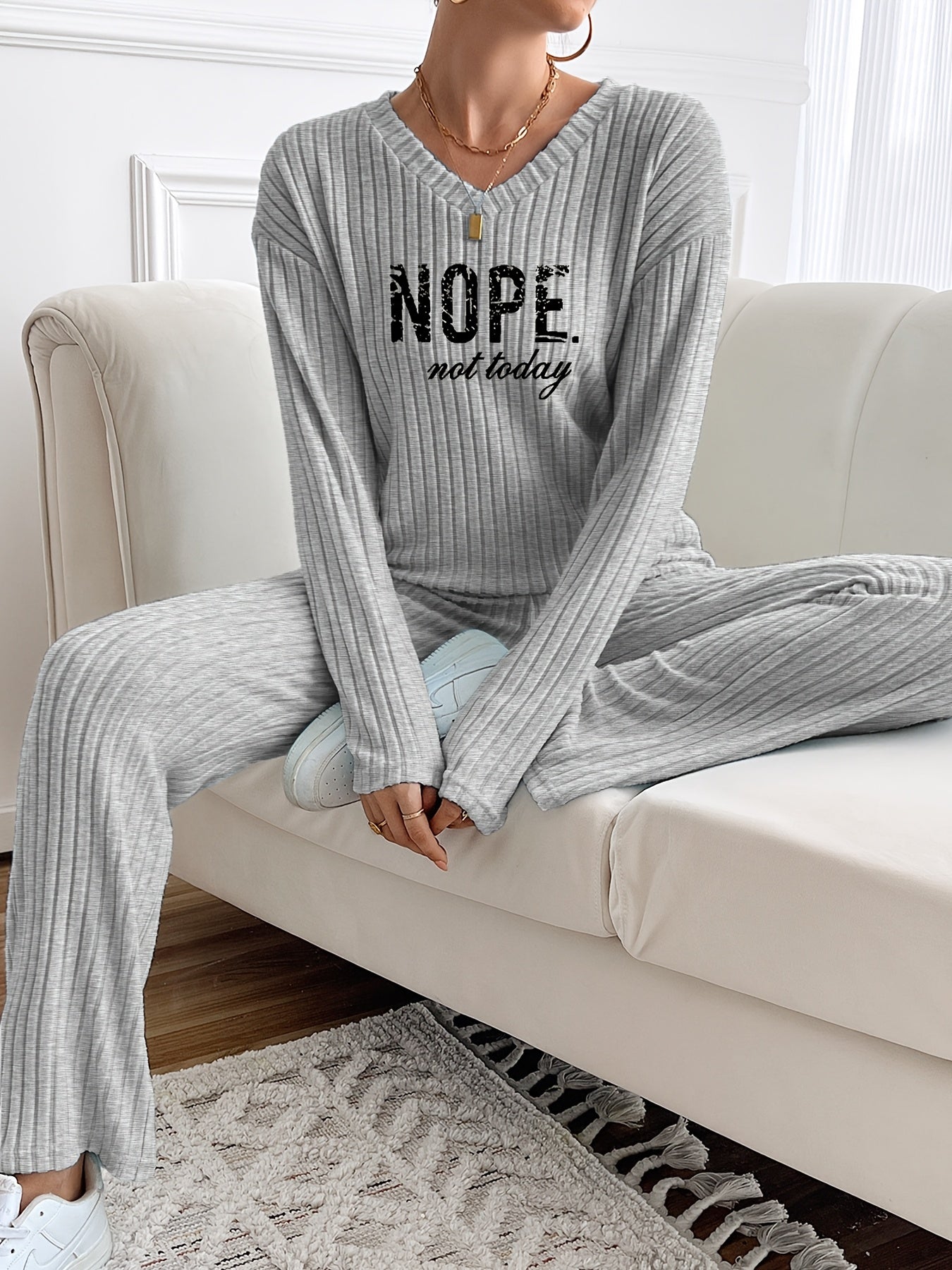 Ribbed women’s two-piece set with a V-neck top featuring lettering and wide-leg pants