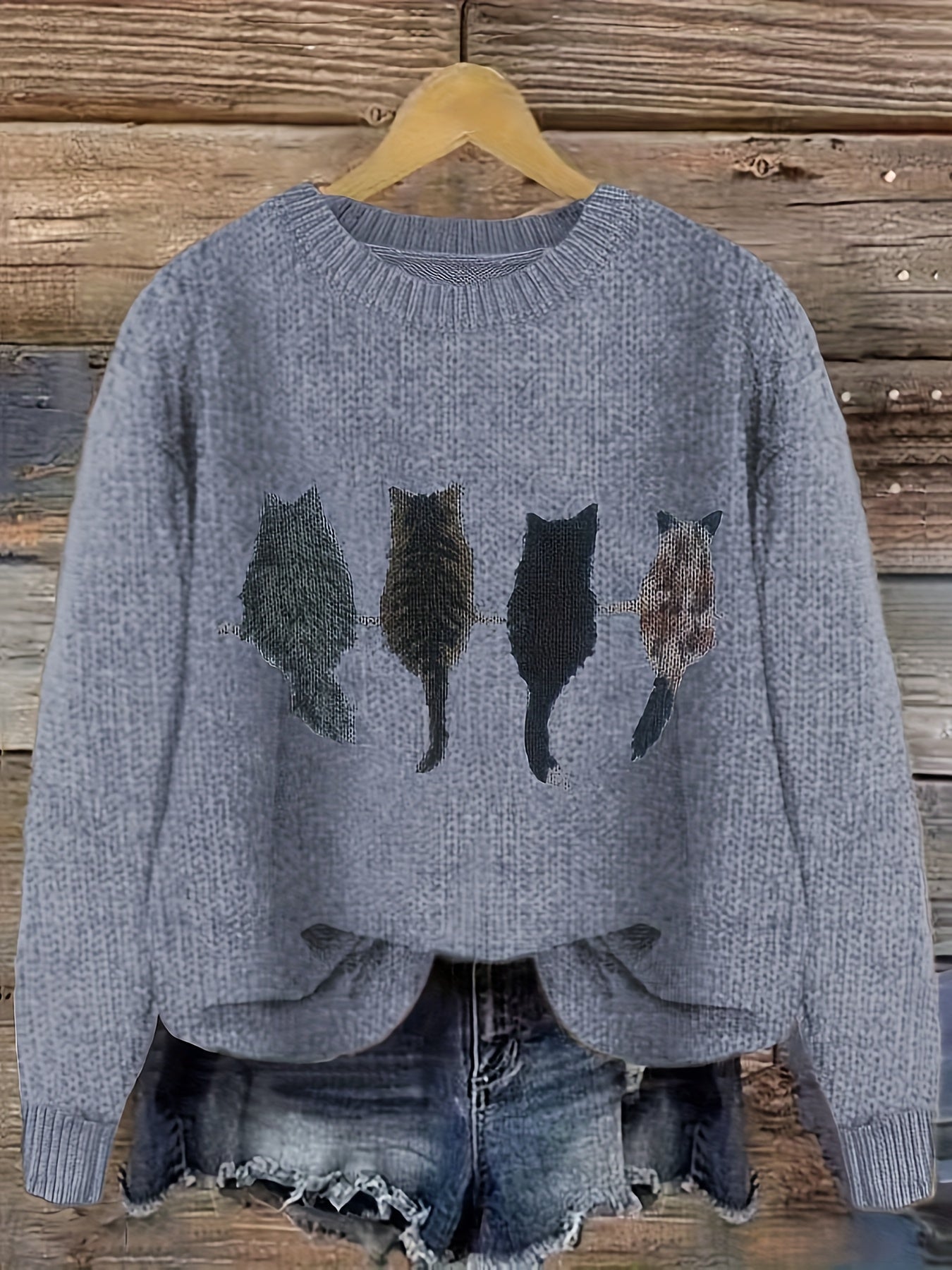 Women's knitted sweater with round neckline and cat motif