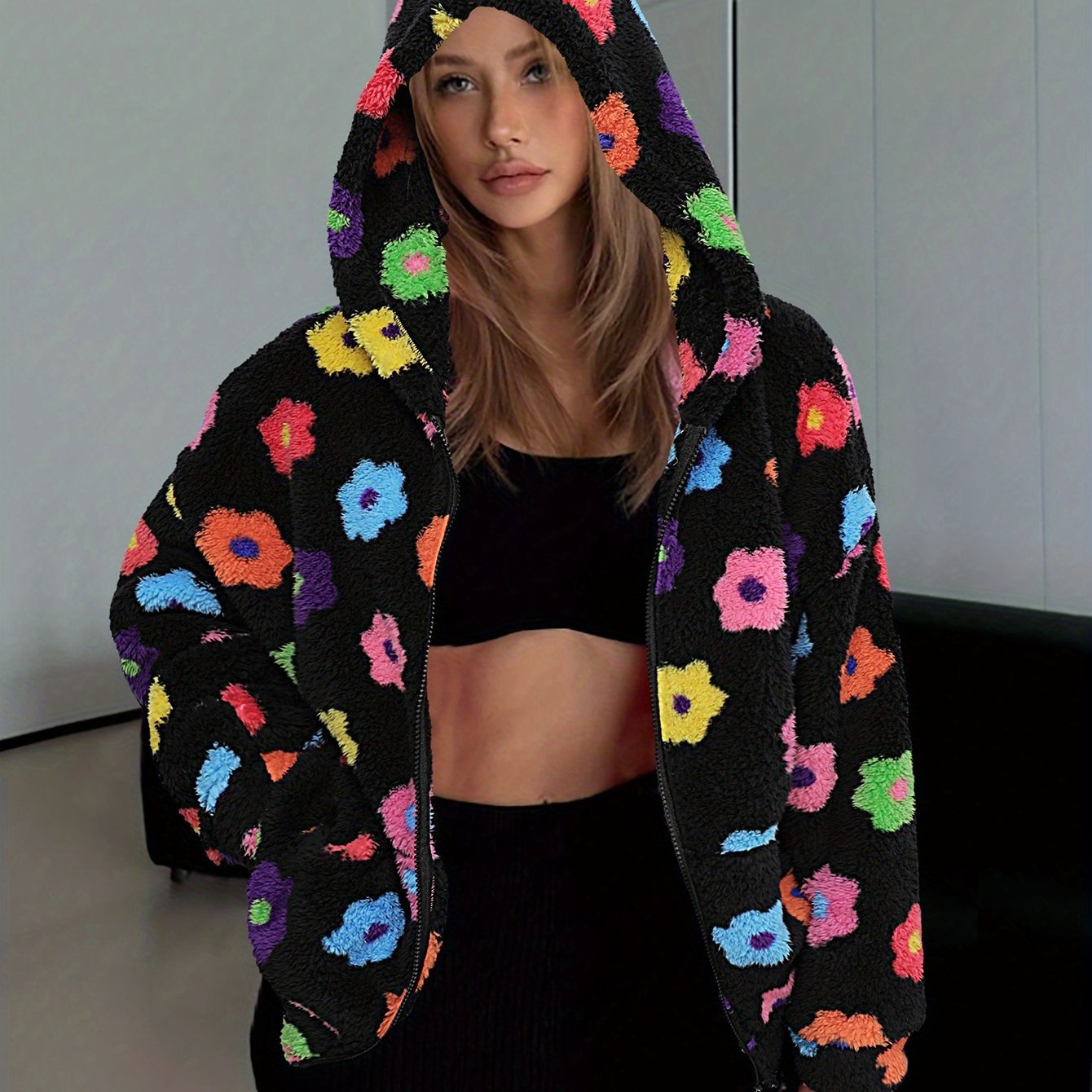 Hooded teddy jacket with colorful floral patterns and a zipper