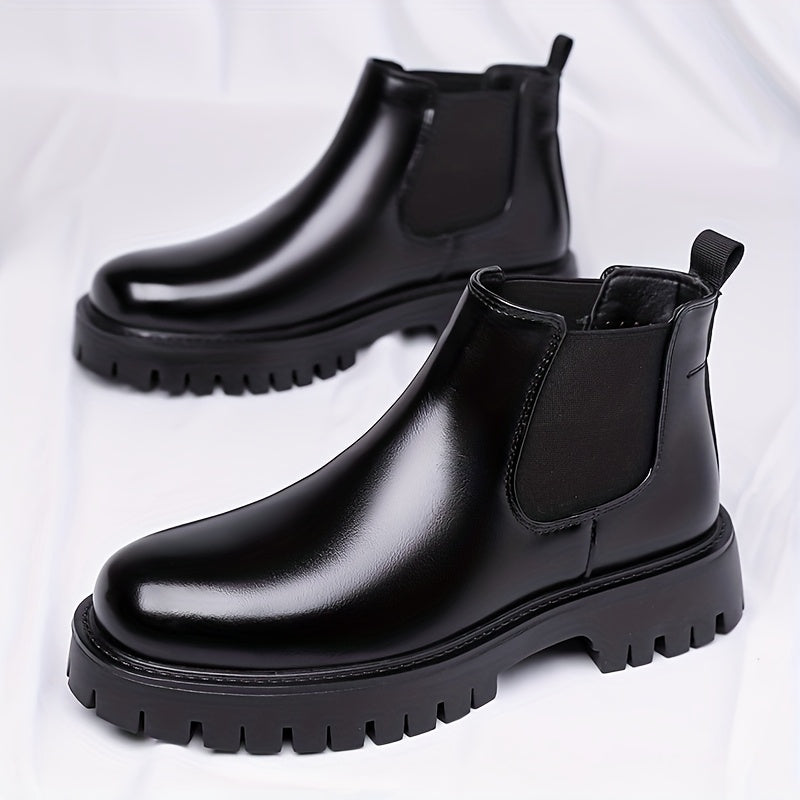 Black Chelsea boots with elastic panels and a lug sole