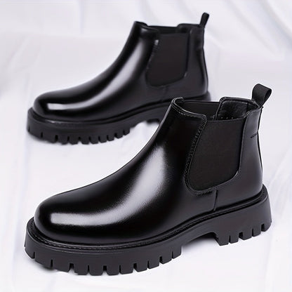 Black Chelsea boots with elastic panels and a lug sole