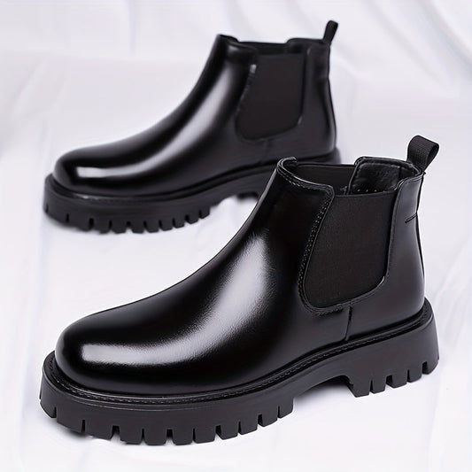 Black Chelsea boots with elastic panels and a lug sole