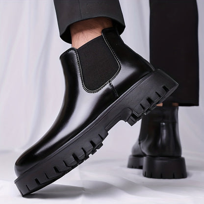 Black Chelsea boots with elastic panels and a lug sole