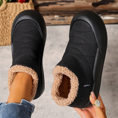 Lined gray ankle boots with quilted uppers and beige plush lining