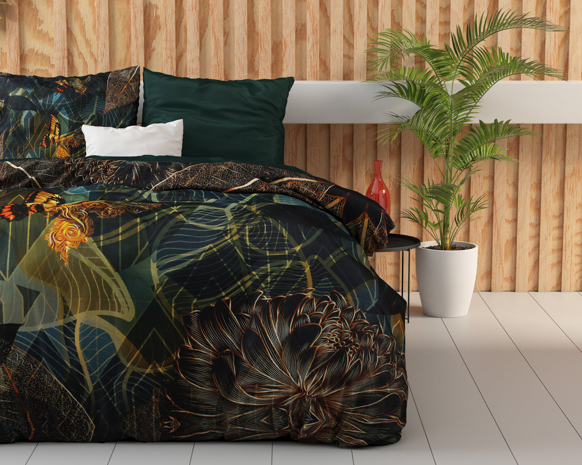 Bed met dekbedovertrek met donkere botanische print, bloem en gouden vlinder, naast een palmplant in witte pot