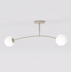 Beige plafondlamp met gebogen arm en twee witte glazen bolkappen tegen een lichte achtergrond