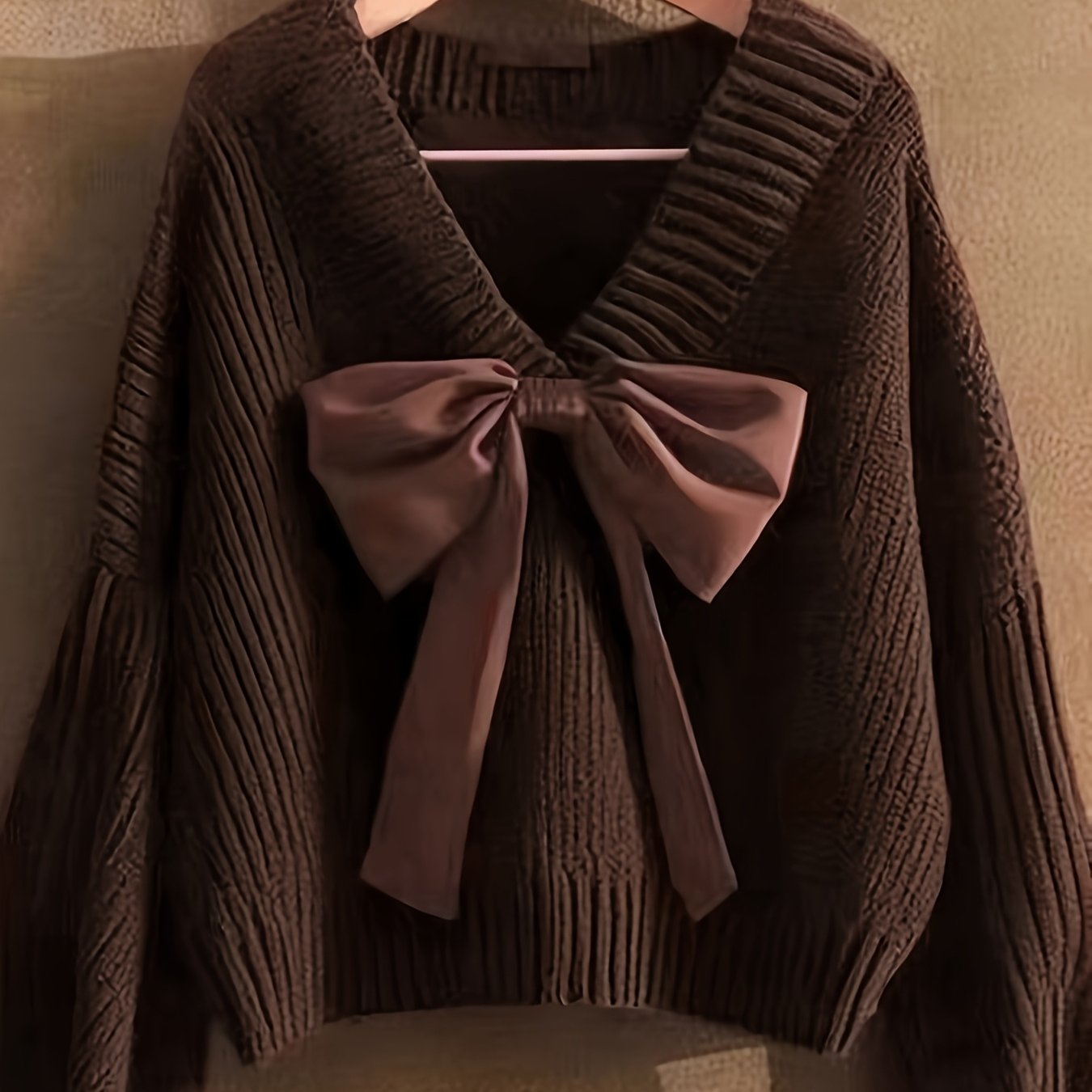 Women's ribbed long-sleeve V-neck sweater with a large bow