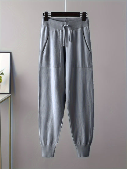 Two-piece women’s knitted set with a V-neck sweater and jogger pants in a beige ribbed-knit design
