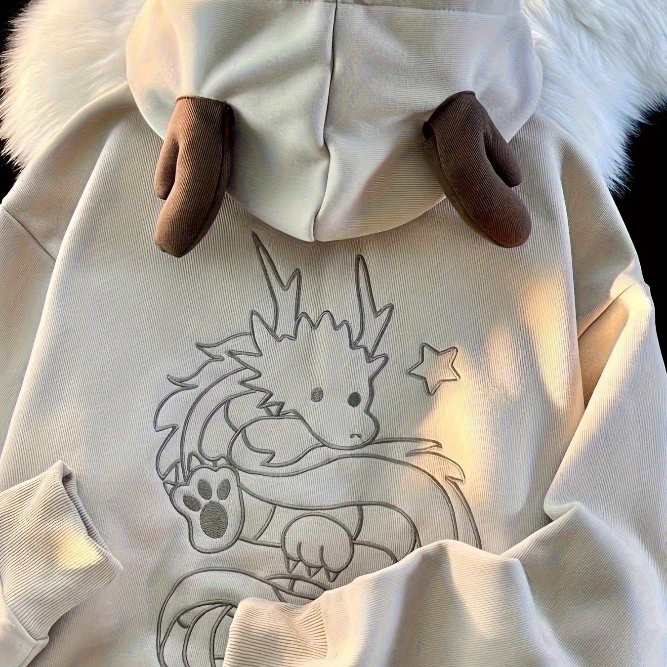 Beige zip-up hoodie with dragon embroidery and antler hood