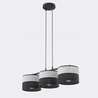 Hanglamp met drie cilindrische kappen in grijs en zwart gaatjesstof aan een zwart frame met twee dunne pendels