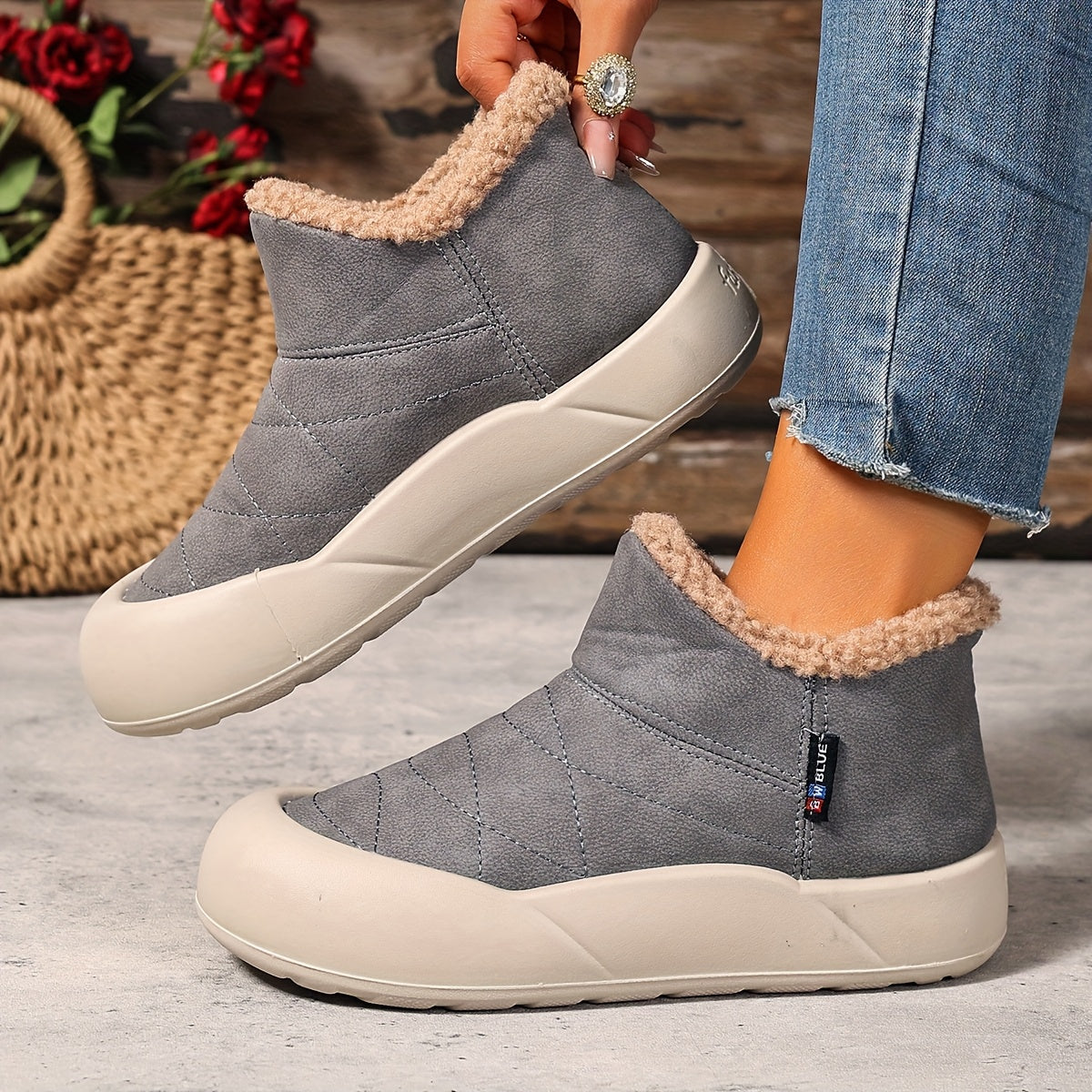 Lined gray ankle boots with quilted uppers and beige plush lining