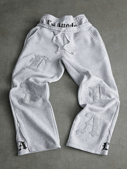 Loose-fit men's joggers with embroidered lettering on the legs, drawstring waistband, black