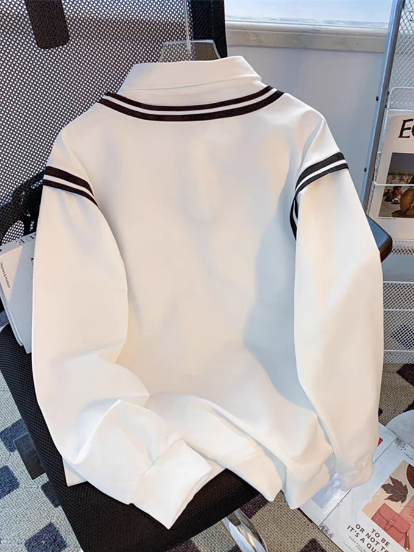 Unisex long-sleeve shirt with a V-neck, white with striped cuffs and “HI” print