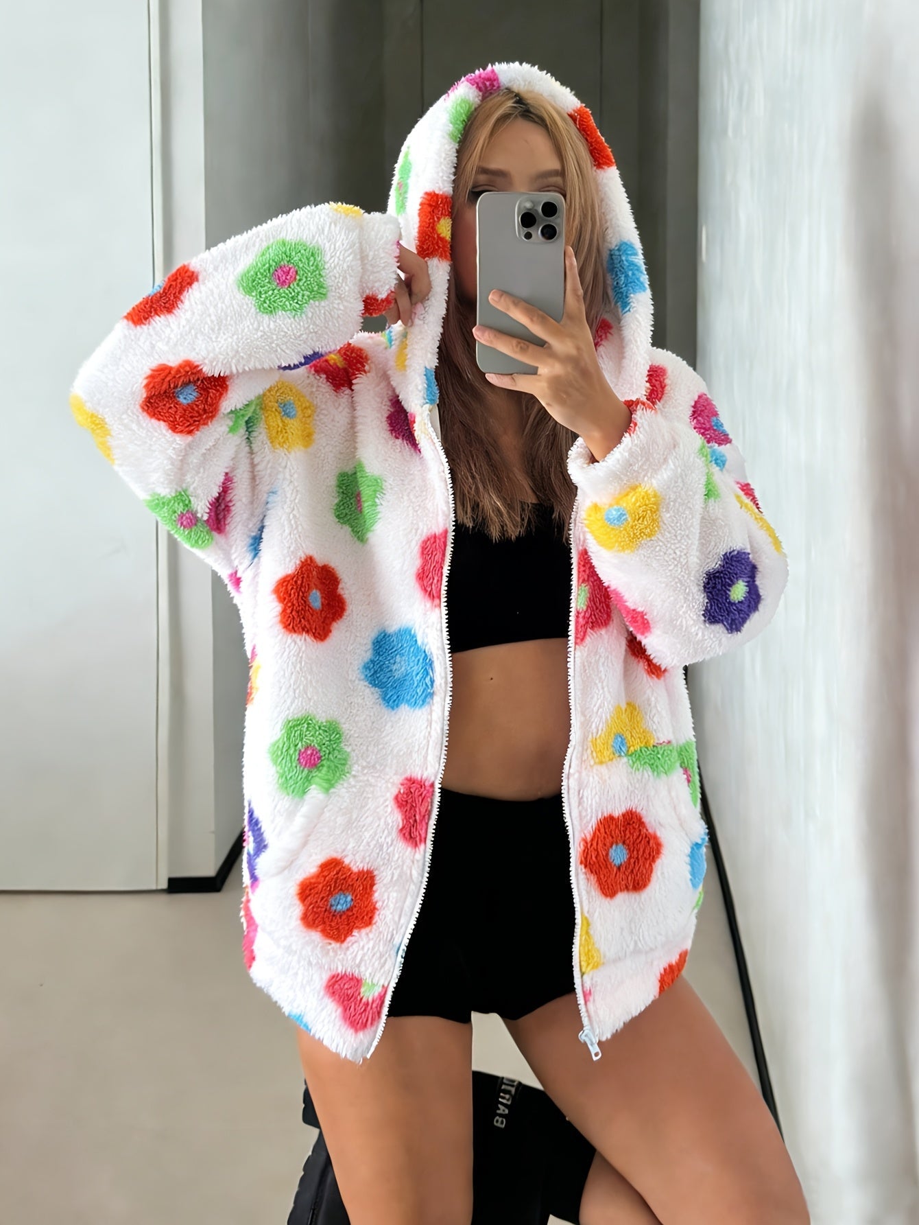 Hooded teddy jacket with colorful floral patterns and a zipper