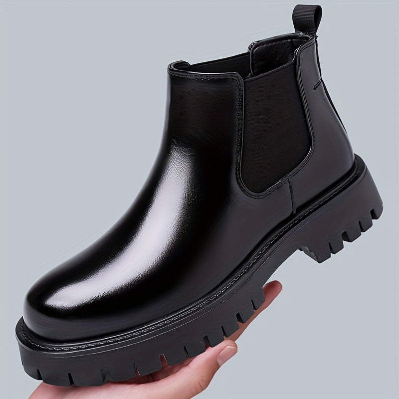 Black Chelsea boots with elastic panels and a lug sole