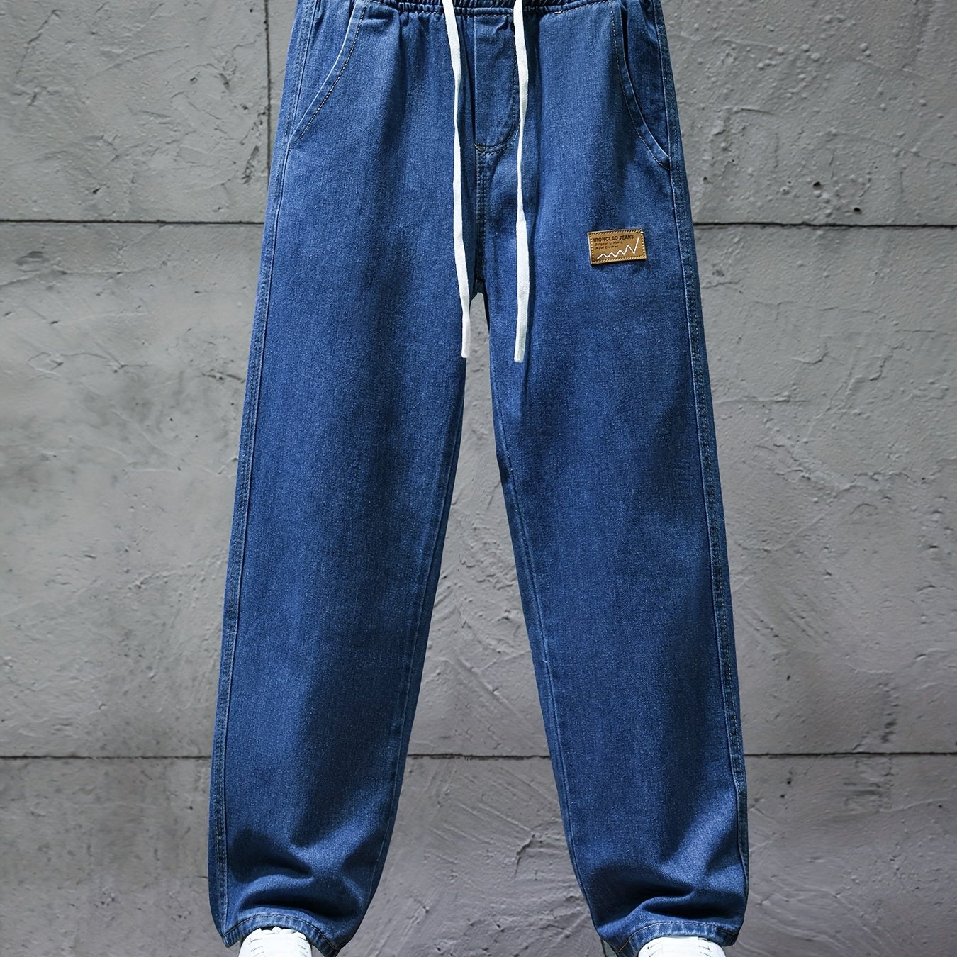 Dark blue jeans with an elastic waistband and drawstring
