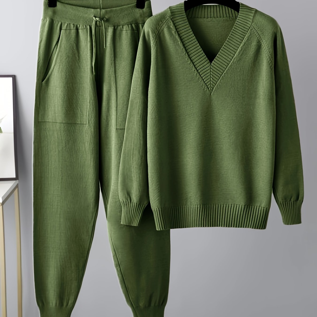 Two-piece women’s knitted set with a V-neck sweater and jogger pants in a beige ribbed-knit design