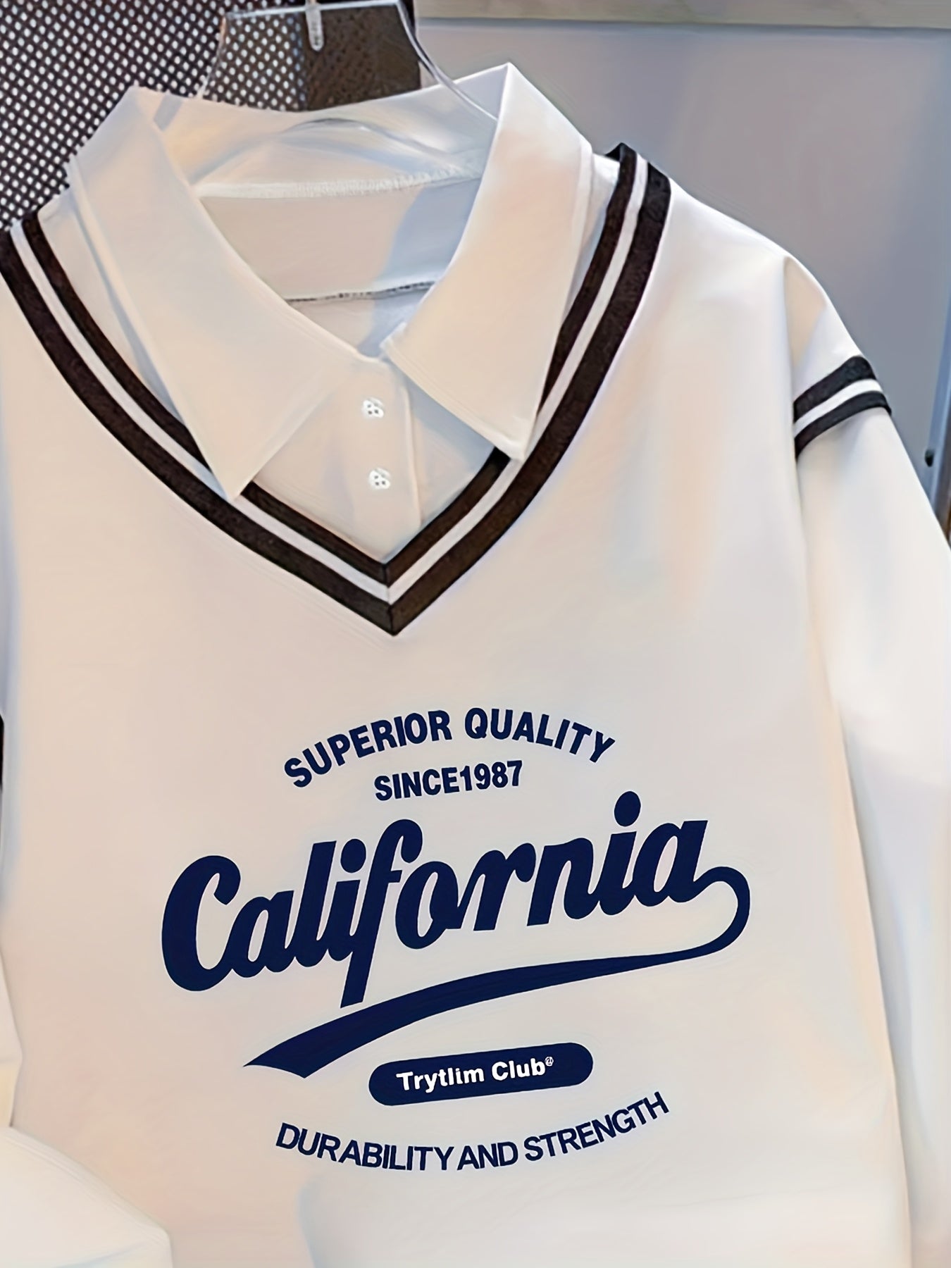 White long-sleeve sweater with collar and California lettering