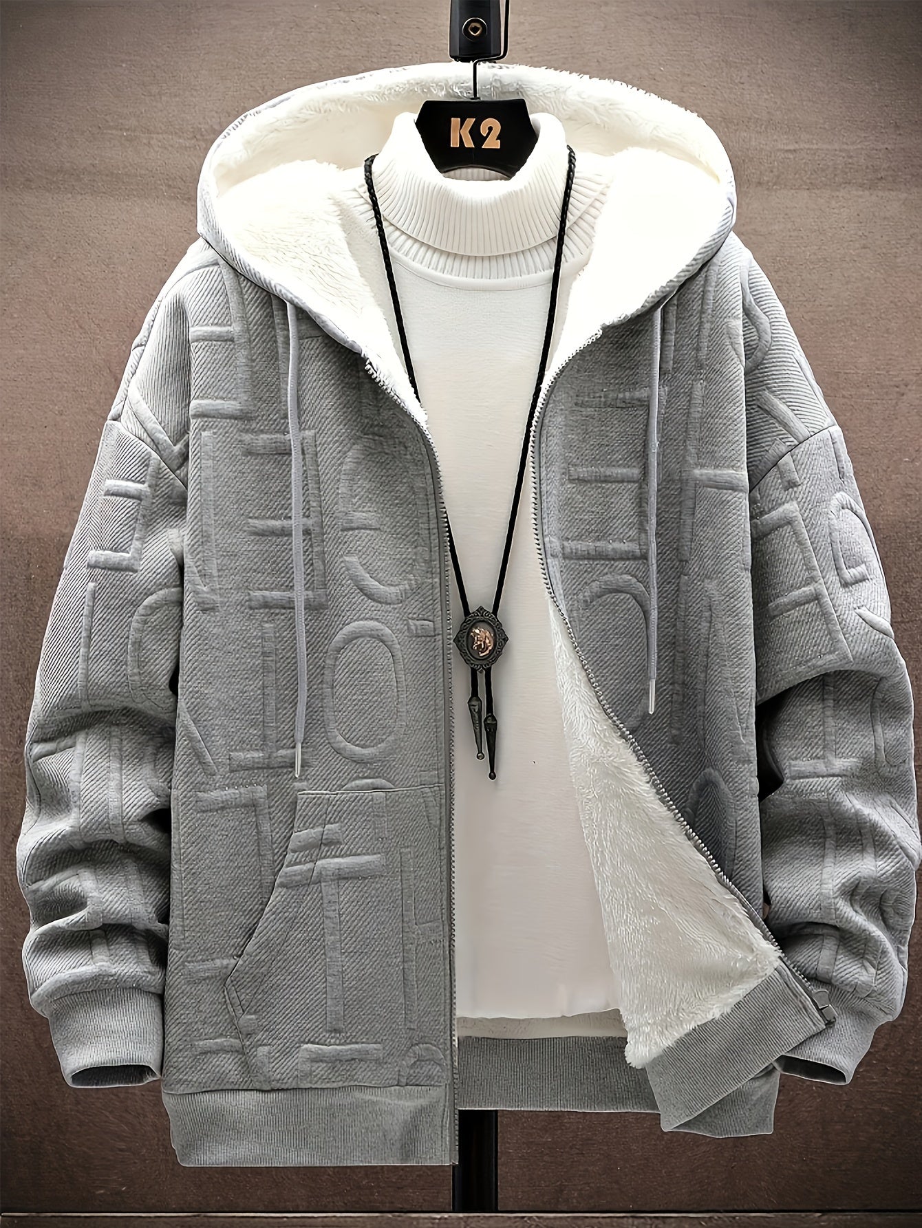 Unisex hooded jacket with fleece lining and raised lettering, zipper, kangaroo pockets, in black