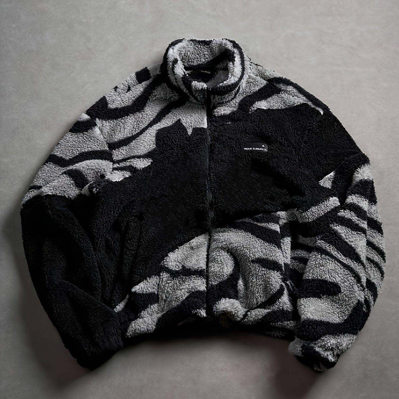 Unisex fleece jacket with stand-up collar, zipper, and animal print