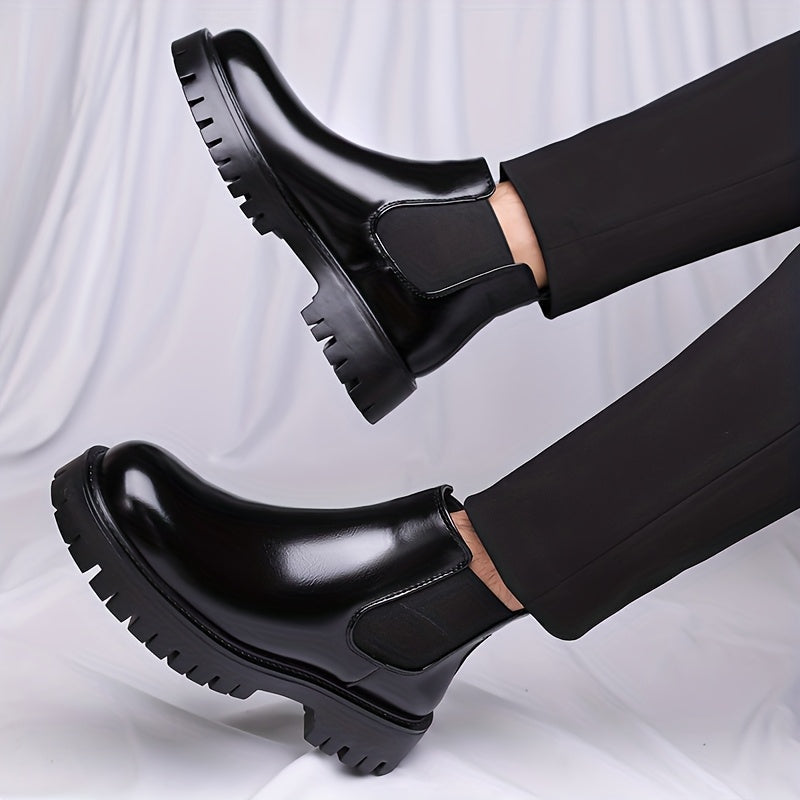 Black Chelsea boots with elastic panels and a lug sole