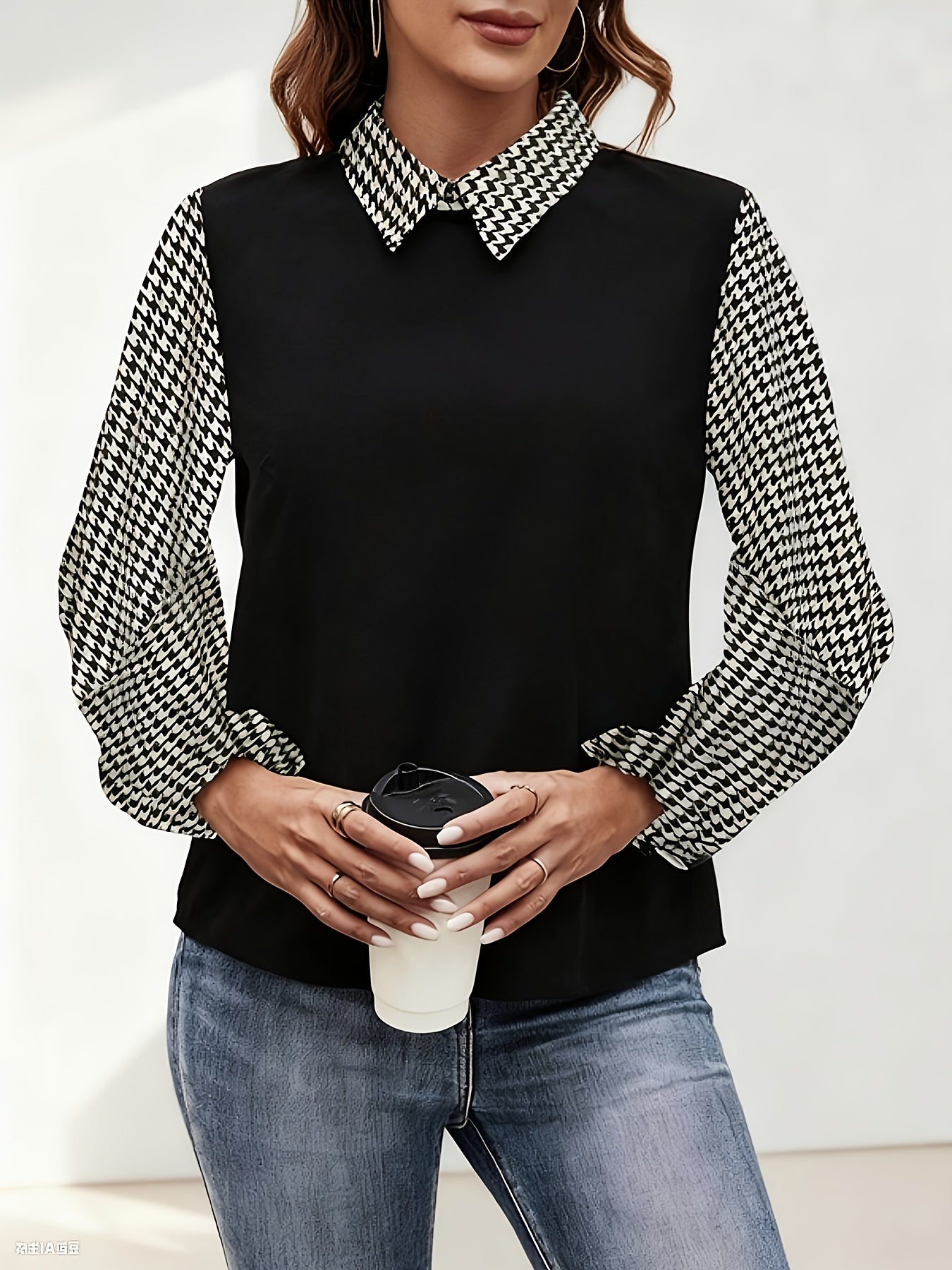 Women's black blouse with houndstooth-patterned sleeves and collar