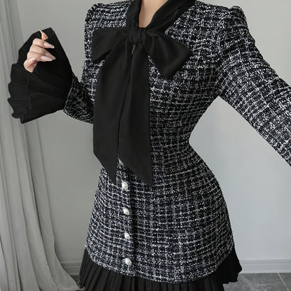 Black-and-white checked dress with a bow and pleated details