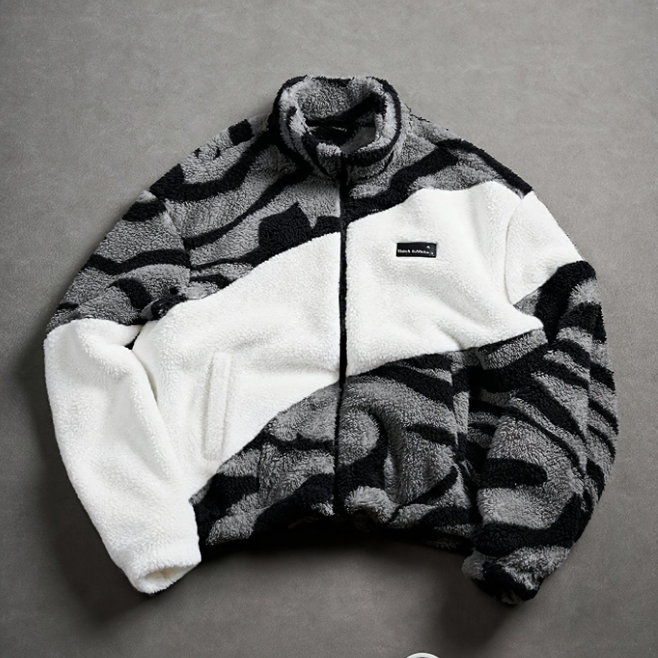 Unisex fleece jacket with stand-up collar, zipper, and animal print
