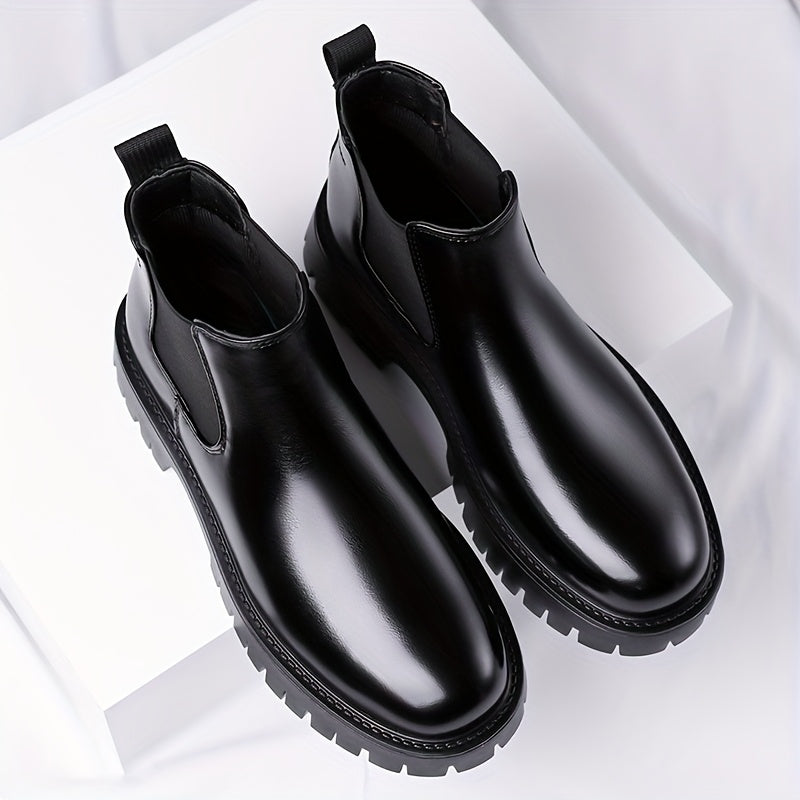 Black Chelsea boots with elastic panels and a lug sole