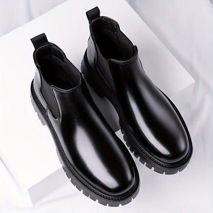 Black Chelsea boots with elastic panels and a lug sole