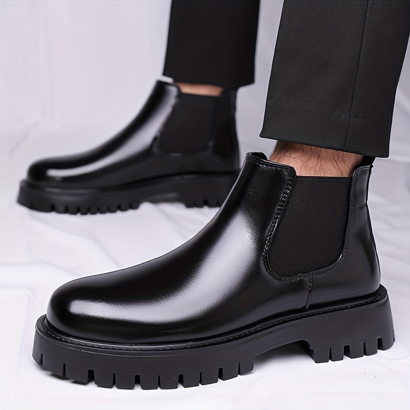Black Chelsea boots with elastic panels and a lug sole