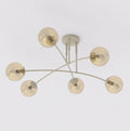 Beige plafondlamp met zes gebogen armen en bolvormige amberkleurige glazen kappen