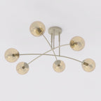 Beige plafondlamp met zes gebogen armen en bolvormige amberkleurige glazen kappen