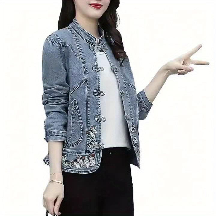 Women's denim jacket with stand-up collar, frog closures, and embroidery