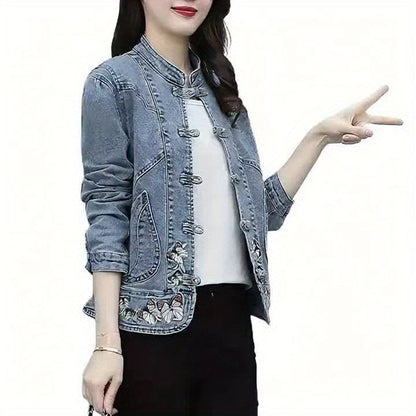 Women's denim jacket with stand-up collar, frog closures, and embroidery