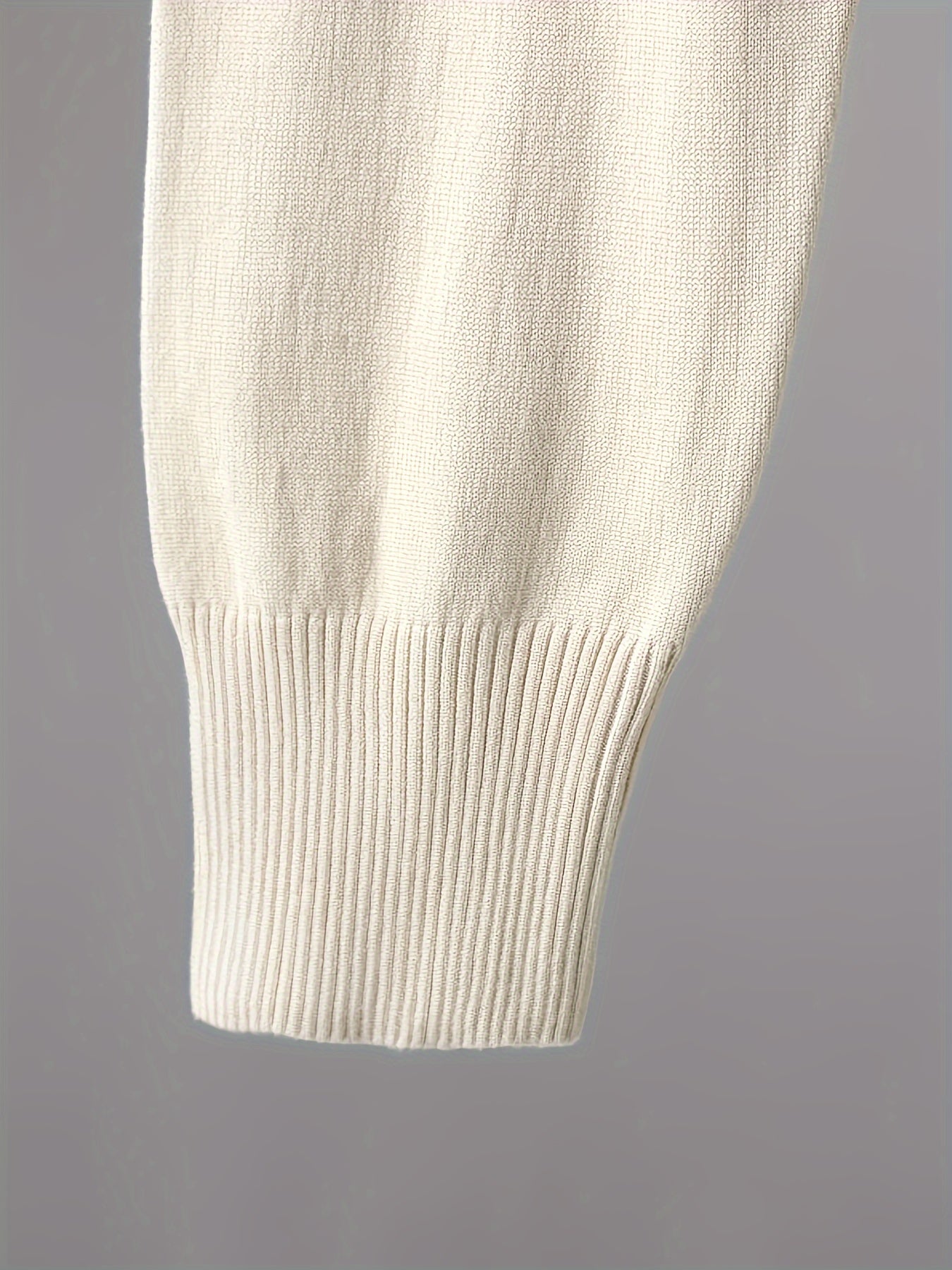 Two-piece women’s knitted set with a V-neck sweater and jogger pants in a beige ribbed-knit design