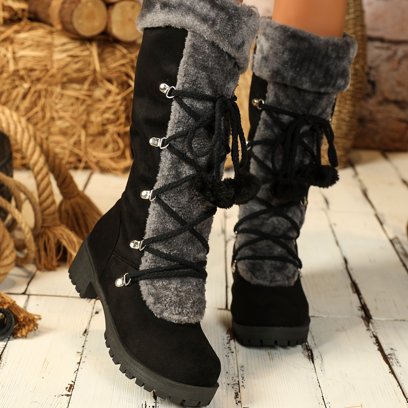 Women's black winter boots with plush trim, laces, and a zipper