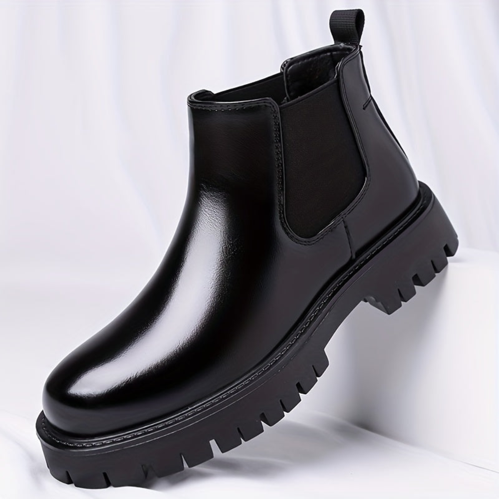 Black Chelsea boots with elastic panels and a lug sole