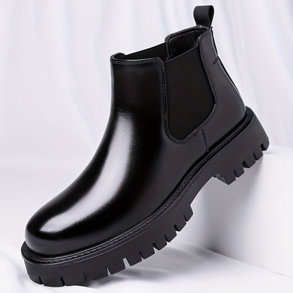 Black Chelsea boots with elastic panels and a lug sole