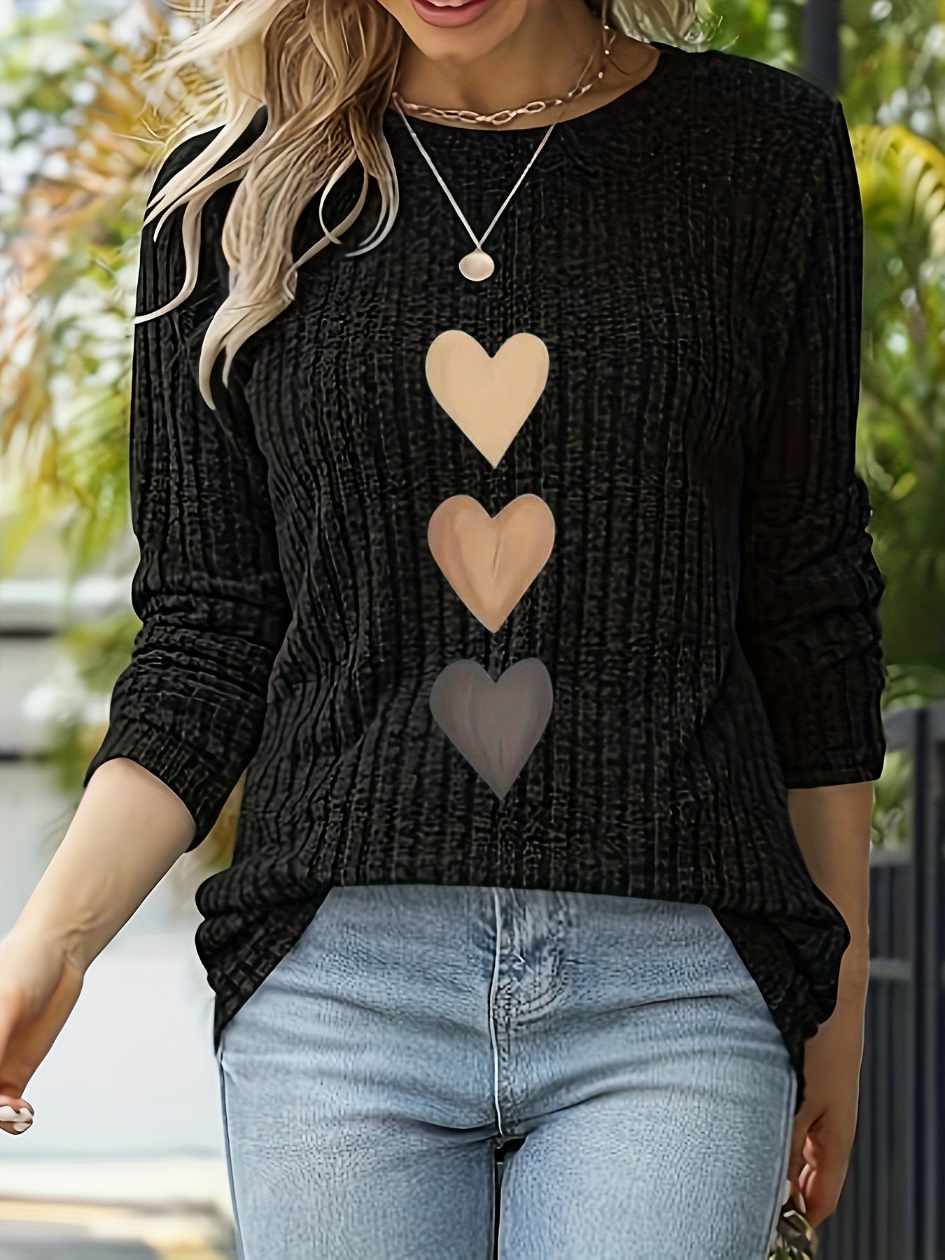 Women's black long-sleeve shirt with heart appliqués