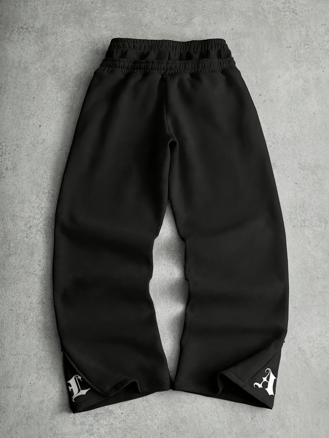 Loose-fit men's joggers with embroidered lettering on the legs, drawstring waistband, black