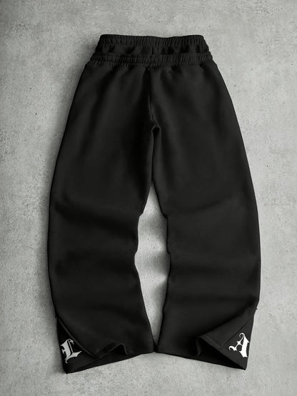 Loose-fit men's joggers with embroidered lettering on the legs, drawstring waistband, black