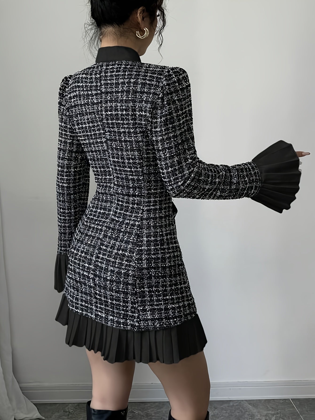 Black-and-white checked dress with a bow and pleated details