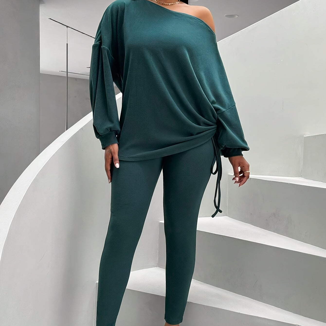 Women's dark green two-piece set with an off-shoulder top and leggings